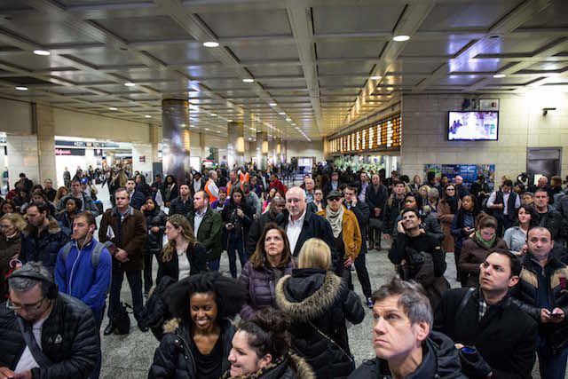Commuters in Penn Station wait to see the fate of their trains after a derailment in March.
